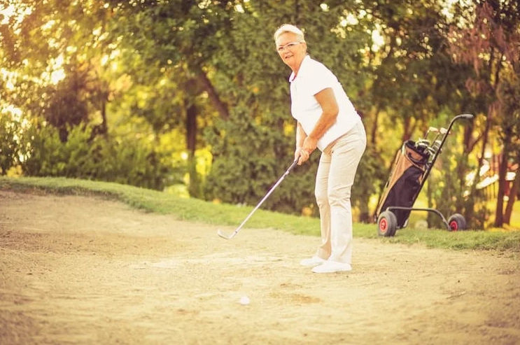 an senior woman playing golf