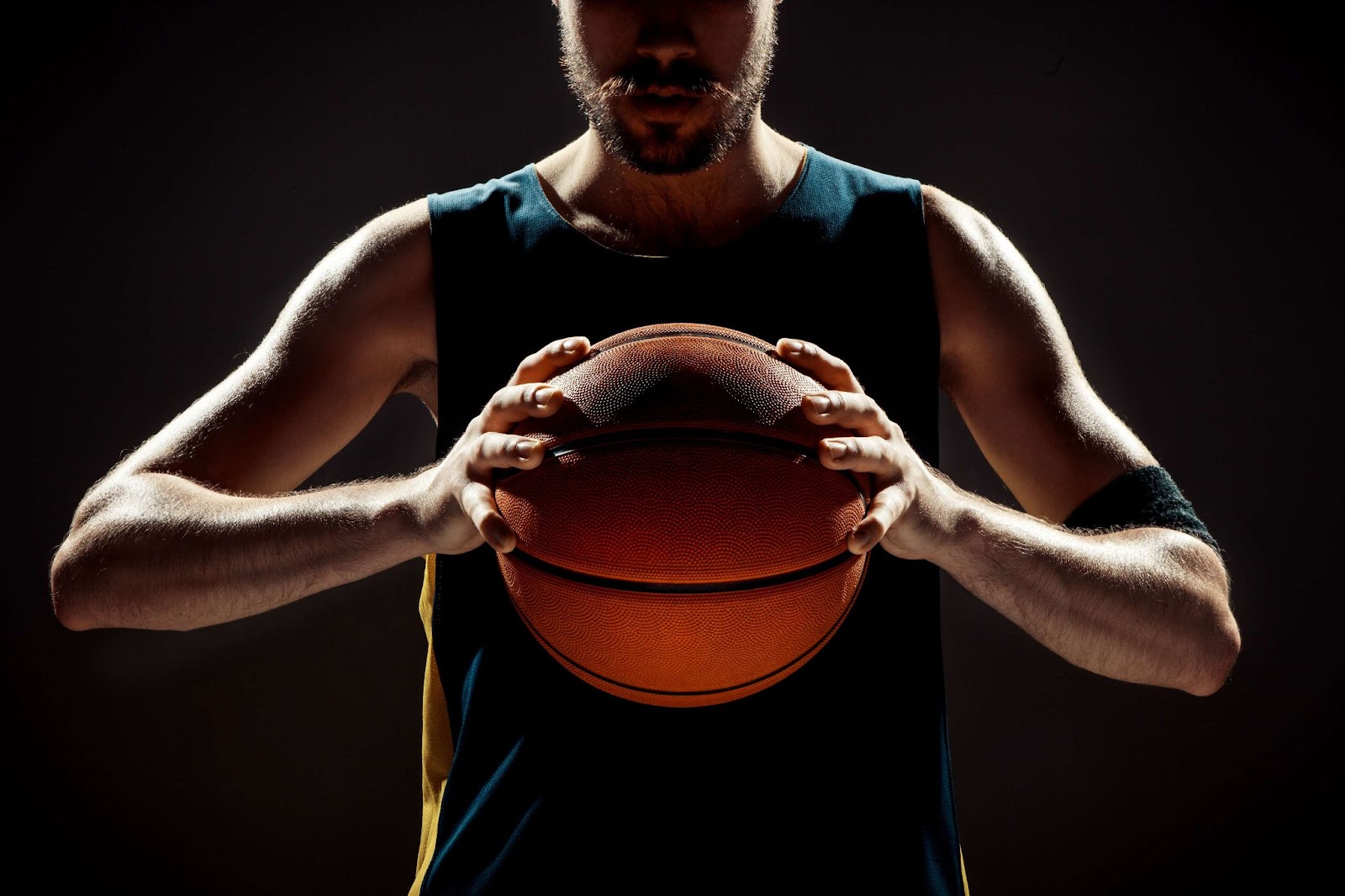 A man holds a basketball in his hands