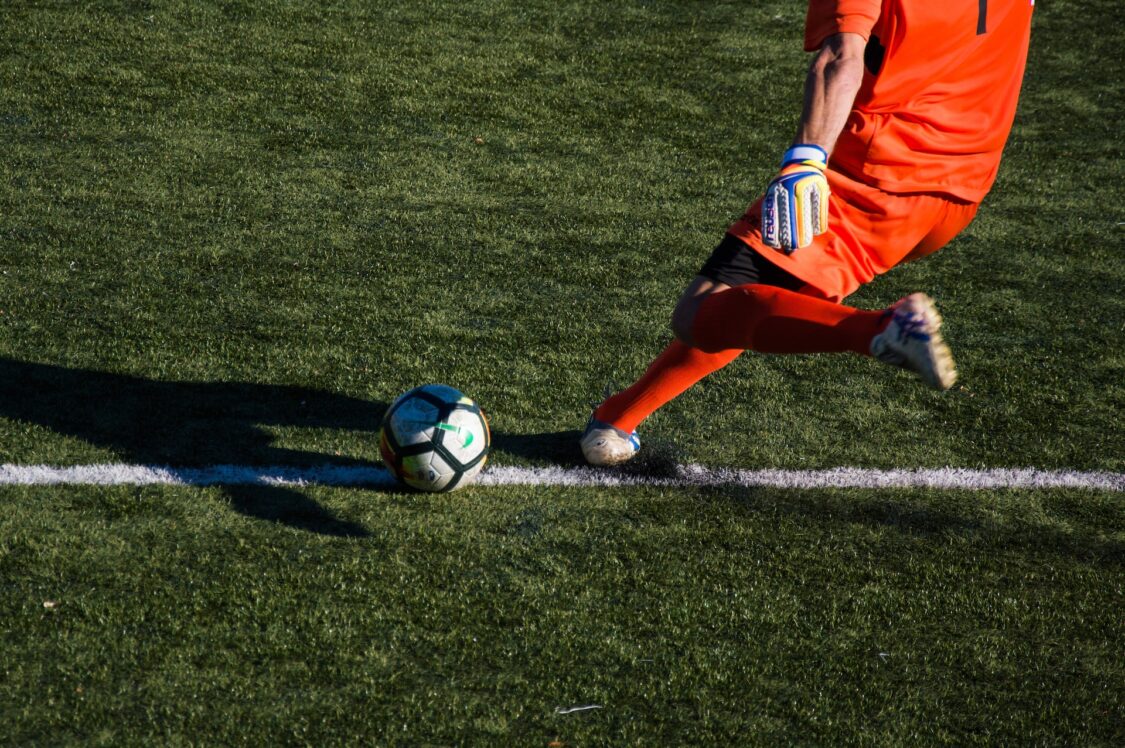 man kicking a ball