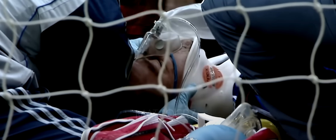 Football player in oxygen mask and brace on the field