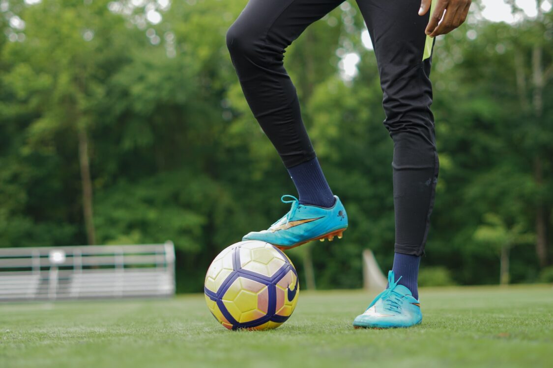man stands with his foot on the ball