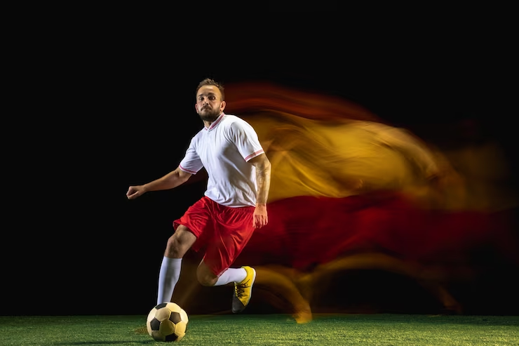 The Soccer Player Kicks the Ball