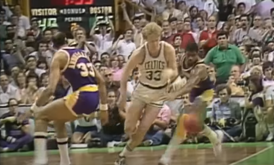Larry Bird playing basketball on court